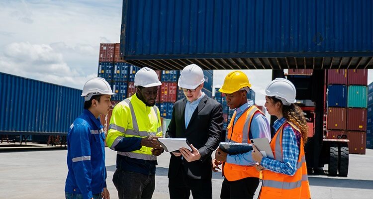 Group of engineer worker and manager standing in the shipping yard container