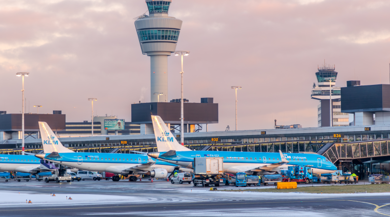 Royal Schiphol Deploys Self-Driving Tug for Baggage Efficiency Schiphol airport with planes outside to support sustainable airport article