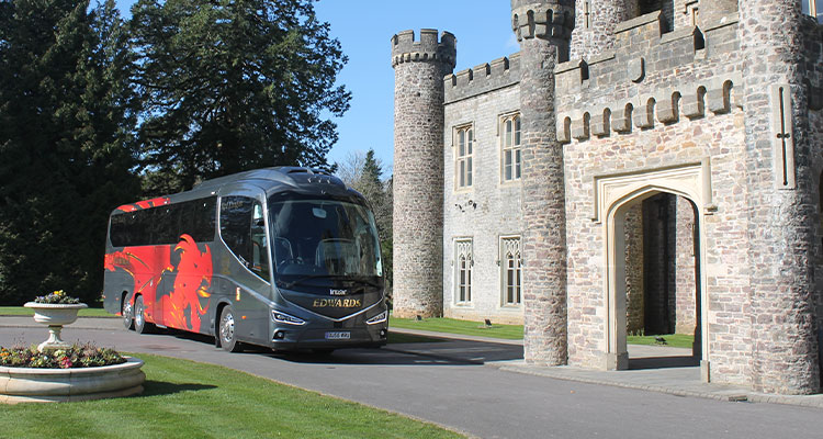 Edwards coach in front of a castle like building