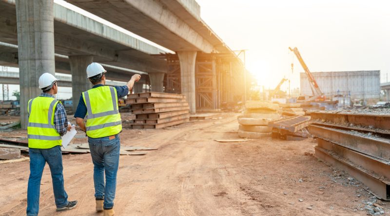 Bridge under construction with two engineers planning on road