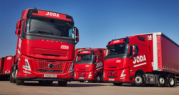 several red Volvo FH Aero trucks belonging to Joda Freight