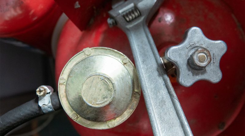 Close up of propane gas cylinder with accessories to support Propane Installation Accessories article