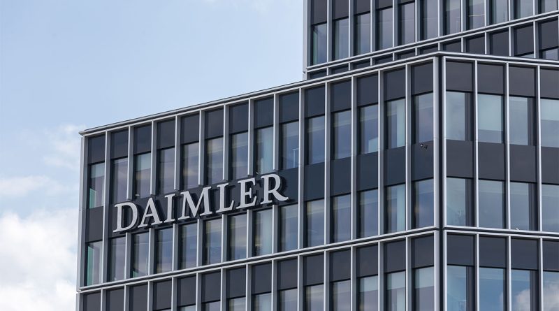 Daimler Truck and Toyota logos with a background of a Japanese truck factory, representing a strategic merger in the commercial vehicle industry.
