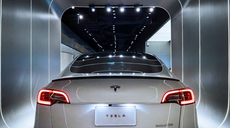 Tesla Model Y electric SUV parked at a Supercharger station