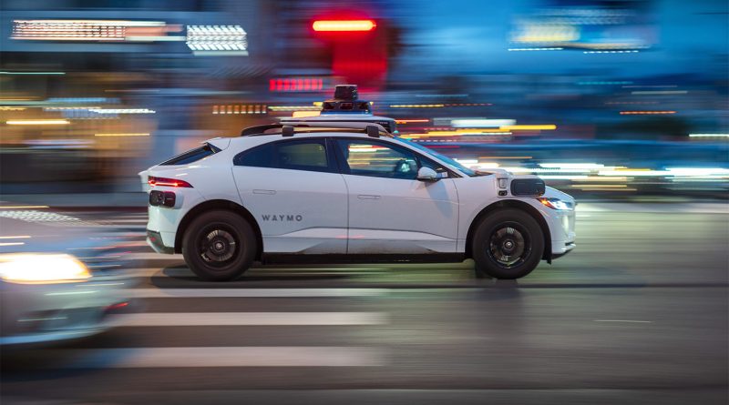 An autonomous Waymo vehicle navigates a busy Boston intersection during early testing