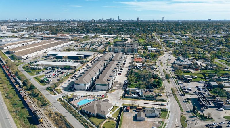 Aerial view of trucks parked at a logistics facility near a Florida highway under clear skies