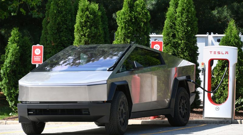 Tesla Cybertrucks in Las Vegas Metro Police livery parked at headquarters with officers nearby