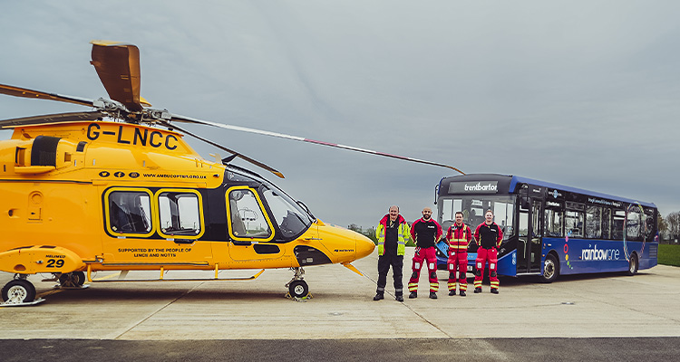 the Lincolnshire & Nottinghamshire Air Ambulance (LNAA) helicopter, registration G-LNCC, alongside a bus from the company trentbarton